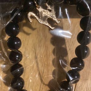 Black beaded bracelet with a black cat charm
